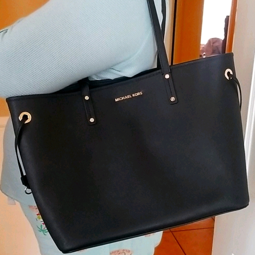 Michael Kors  black with a hand strap  clutch
